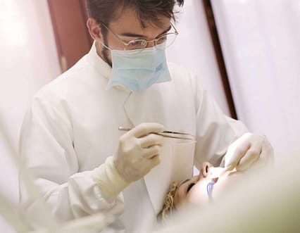 man-in-white-long-sleeve-shirt-holding-a-dental-tool-3779696 affordable dentist