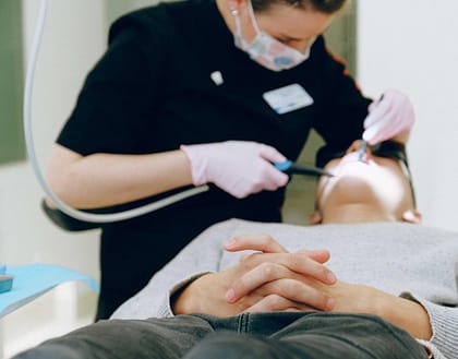 dentist-with-patient-lying-down expensive dental hygienist