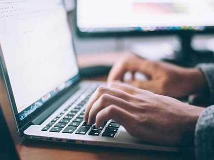 person-on-computer searching-online-for-clip-on-veneers