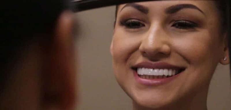 Maria looks at her new BIL Veneers in the mirror